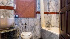 A bathroom with a marble sink, toilet, and bathtub. - Nipa Resort (Phuket)