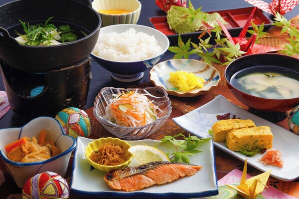 A variety of Japanese dishes including sushi, sashimi, and rice bowls.