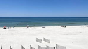 A beach with white sand, a clear blue sky, and calm sea. - Gulf front, North Cape, huge outdoor lounge, fenced pet area!!!! (Port St Joe)