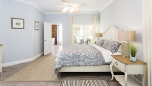 A bedroom with a bed, bedside tables, a nightstand, a ceiling fan, and a view of a balcony. - MARCH LAST MINUTE AVAILABLE! (Davenport)