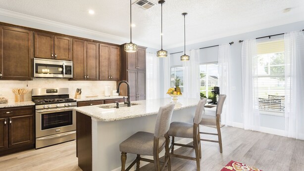 A kitchen with wooden cabinets, stainless steel appliances, a granite countertop, and pendant lighting. - MARCH LAST MINUTE AVAILABLE! (Davenport)