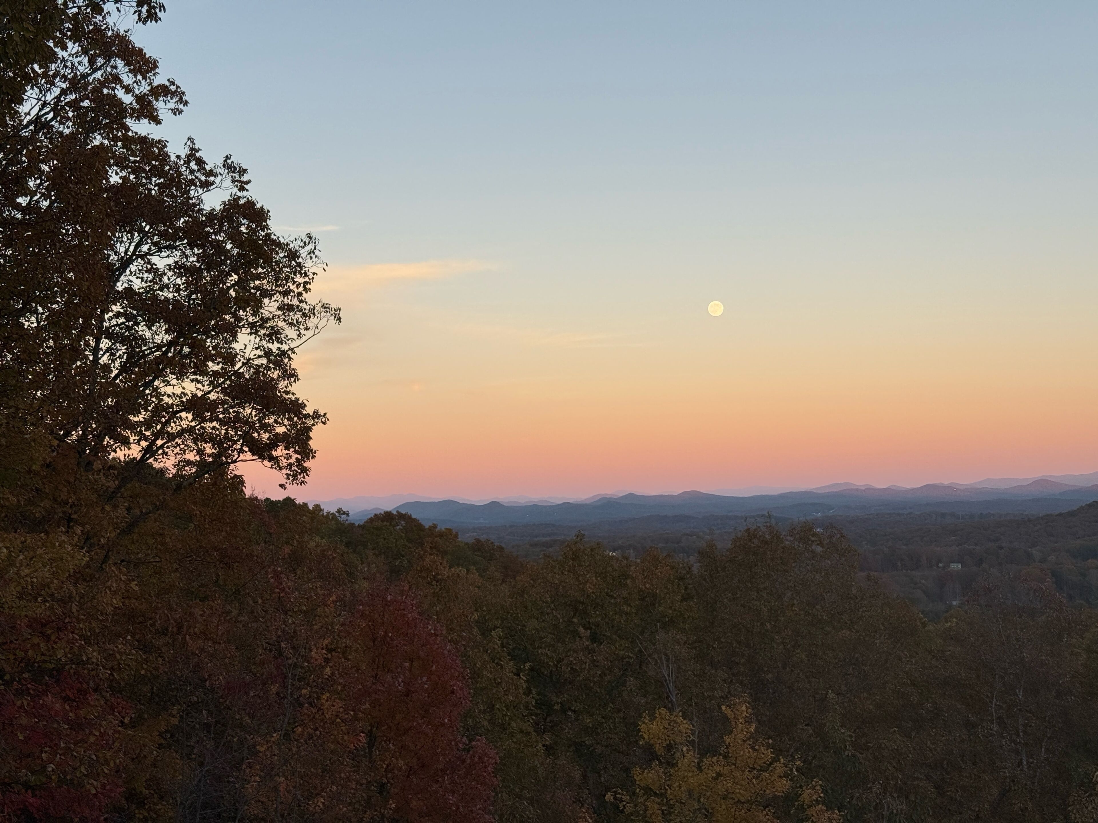 A landscape with a mountain range and a clear sky.