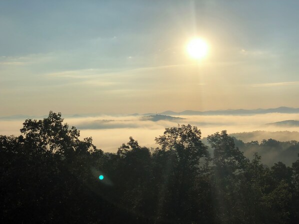 A sunrise over a mountainous landscape with trees in the foreground. - Long Range Views! 3 Fireplaces-Sleeps 20-Blue Ridge-Pool Table/HotTub-Pets OK. (Blue Ridge)