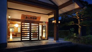 A traditional Japanese building with a wooden entrance and a sign in Japanese. - Bekkan Fujiya Ryokan (Kaminoyama)