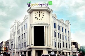 A hotel with a prominent clock tower, a large entrance, and a sign indicating it is a 'Goldberry Lite Hotel'. - Goldberry Lite Hotel (Ilo-Ilo City )