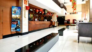 A hotel lobby with a reception desk, a digital screen, and a staircase. - Junikastay Blagoon Melaka (Malacca City)