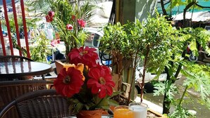 A breakfast table with eggs, toast, watermelon, and a cup of coffee. - P R Patong Hotel (Patong)