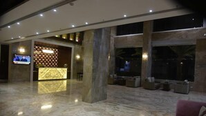 A spacious lobby with a marble floor, a reception desk, and seating areas. - Pride Hotel & Convention Centre Indore (Indore)