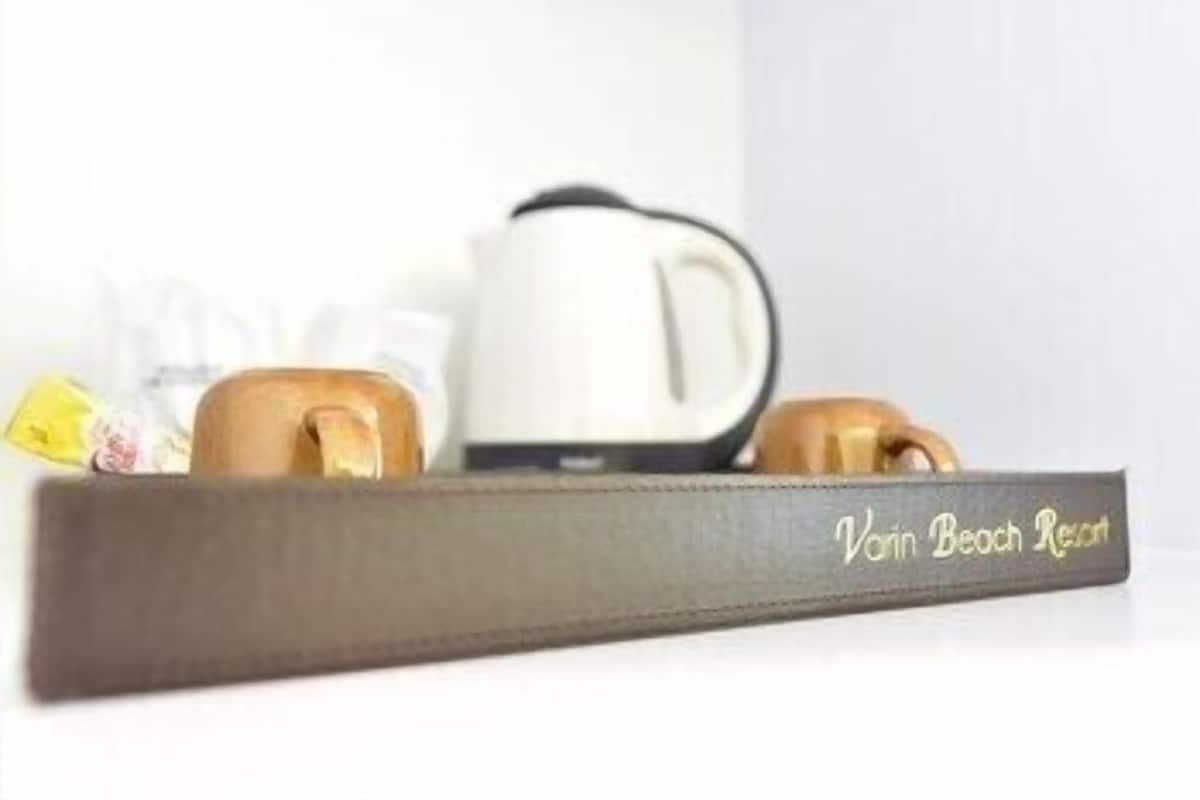 A tray with a coffee maker and two cups, labeled 'Vain Beach Resort.'