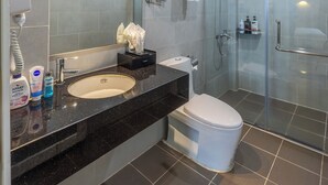 A modern bathroom with a large mirror, a sink, a toilet, and a glass-enclosed shower. - A25 Premium Hotel - 142 Bui Thi Xuan (Ho Chi Minh City)