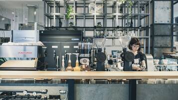 A modern coffee shop with a barista preparing drinks.