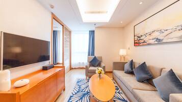Deluxe Suite | Living room | TV, iPod dock