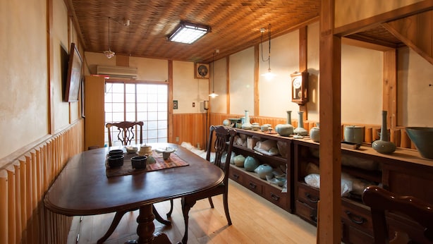 A traditional Japanese-style room with a wooden ceiling, a tatami mat table, and a tea set. - Kyoto Tenseian (Kyoto)