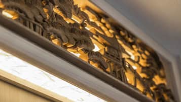 A detailed carved wooden panel with intricate designs, likely part of a building's interior architecture.