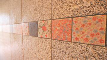 A tiled floor with a mix of plain and floral patterns.