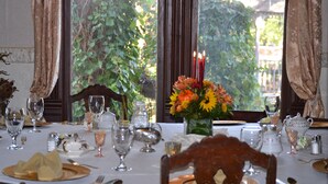 A dining table set for a meal with various glassware, plates, and cutlery. - The Carleton House (Bonham)