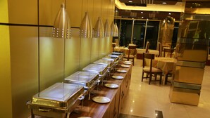 A buffet setup with multiple serving stations and chairs.