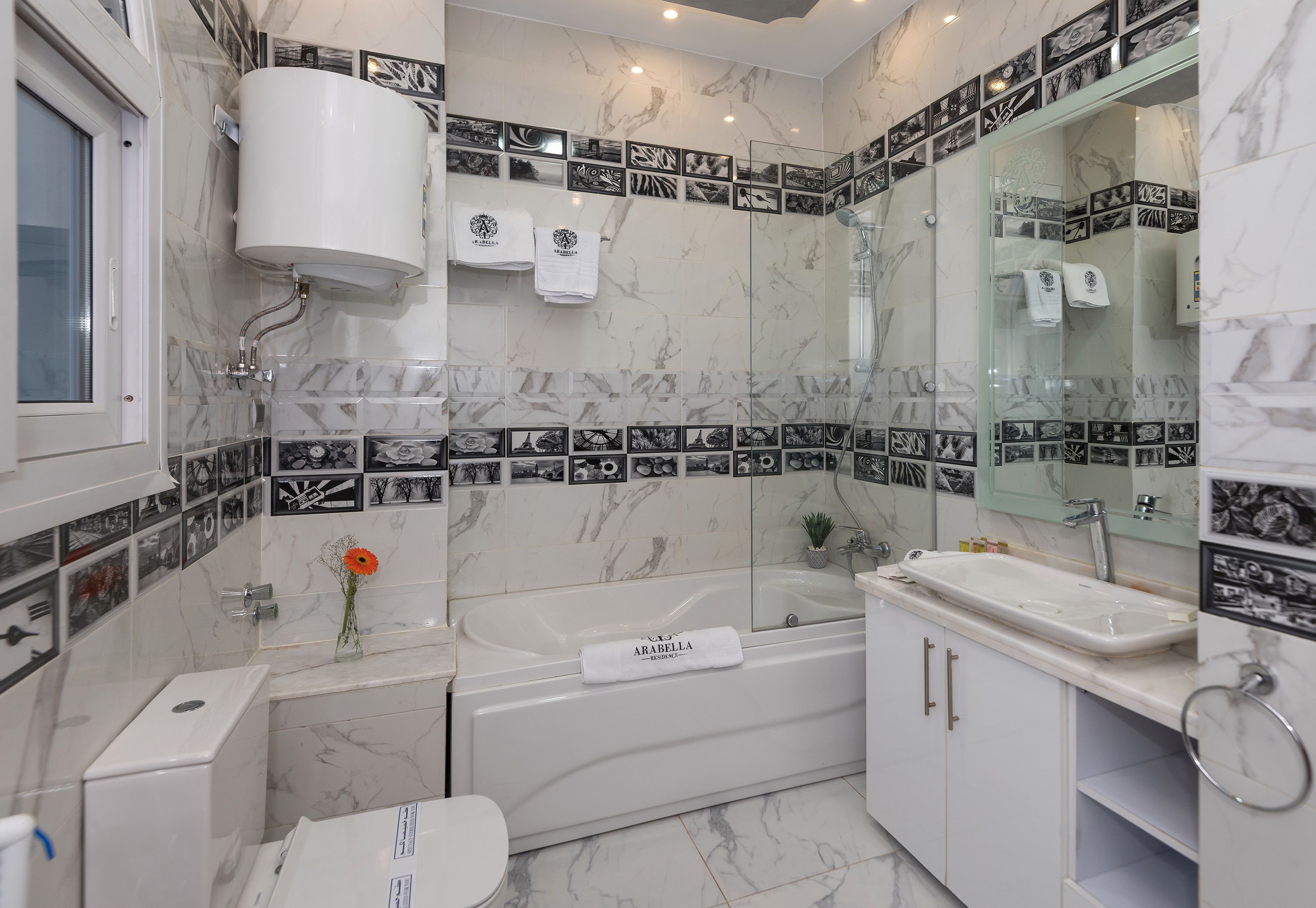 A modern bathroom with a bathtub, a sink, and a toilet.
