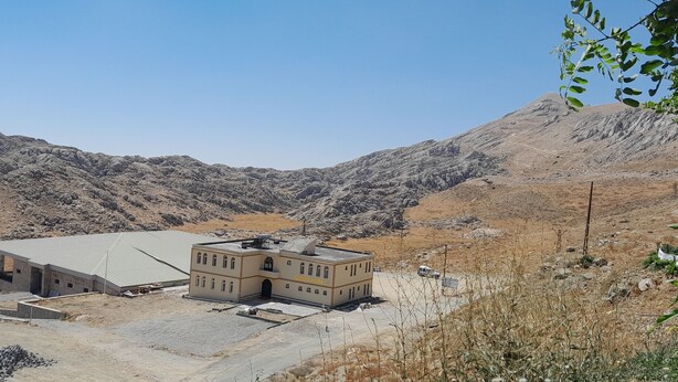 A hotel with a flat roof and a two-story building, surrounded by rocky mountains. - Sunrise Güneş Motel (Pütürge)