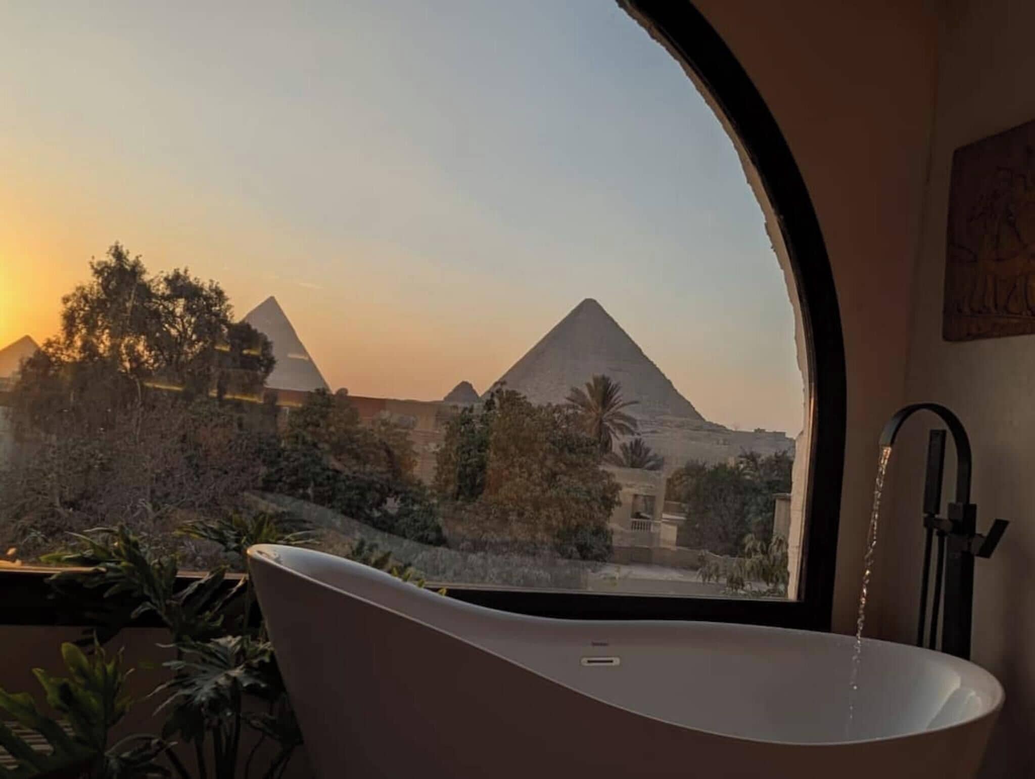 A bathtub with a view of the pyramids.