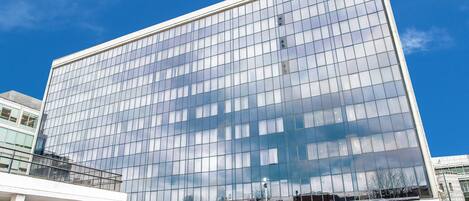 A modern building with a glass facade and a storefront named "livin'".