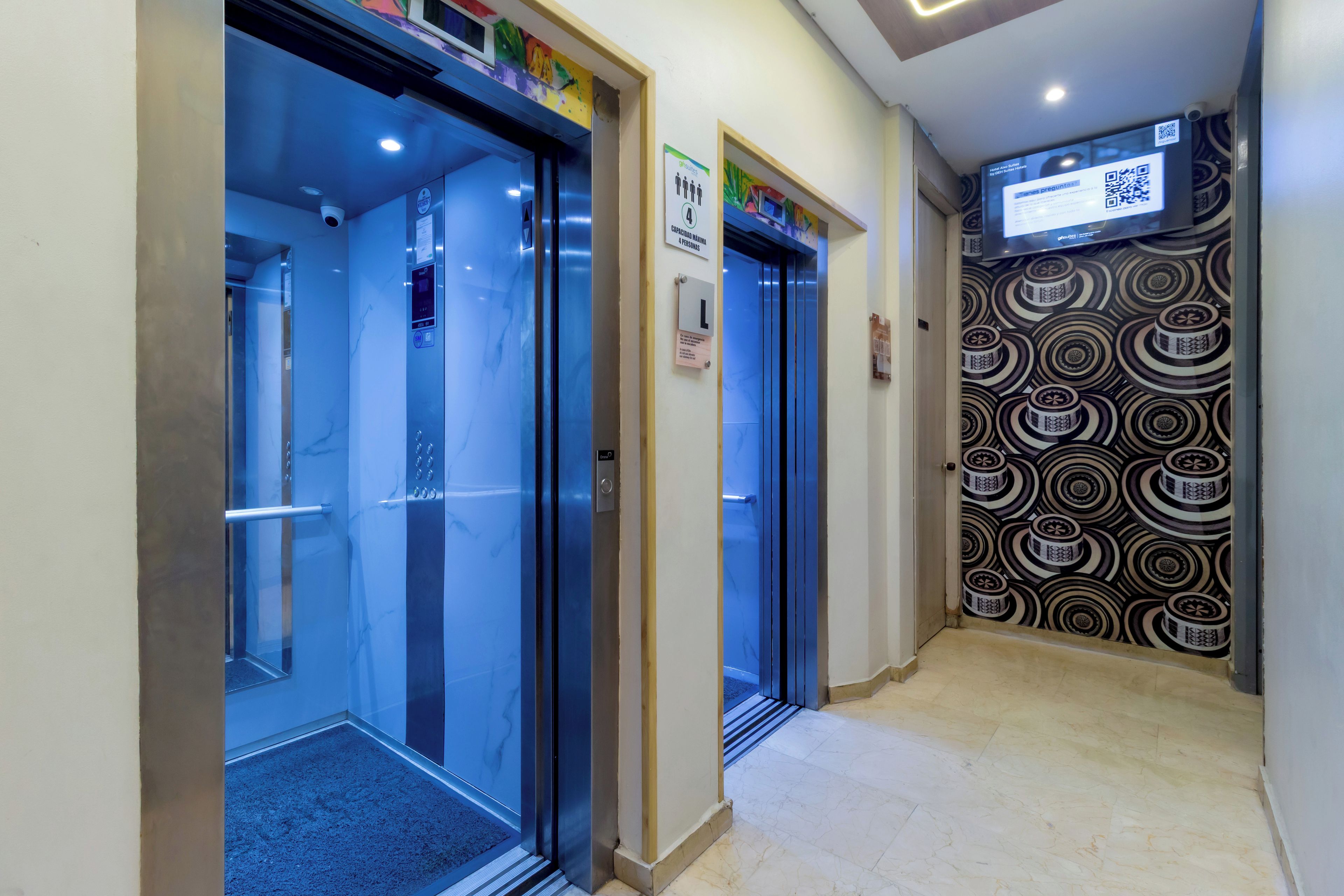 An elevator with a digital display and a sign indicating a maximum capacity of 4 people.