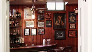 Siebken's Pub interior with wooden walls, a bar area, and various framed pictures. - Siebkens Resort (Elkhart Lake)