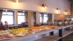 Un bufé con diferentes opciones de comida y una larga barra.
