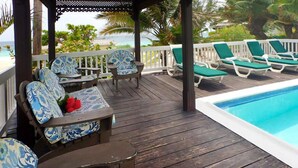 A wooden deck with lounge chairs and a pool. - Sea Spray 50 Steps to the Sea, Silver Sands, 3 BR (Duncans)