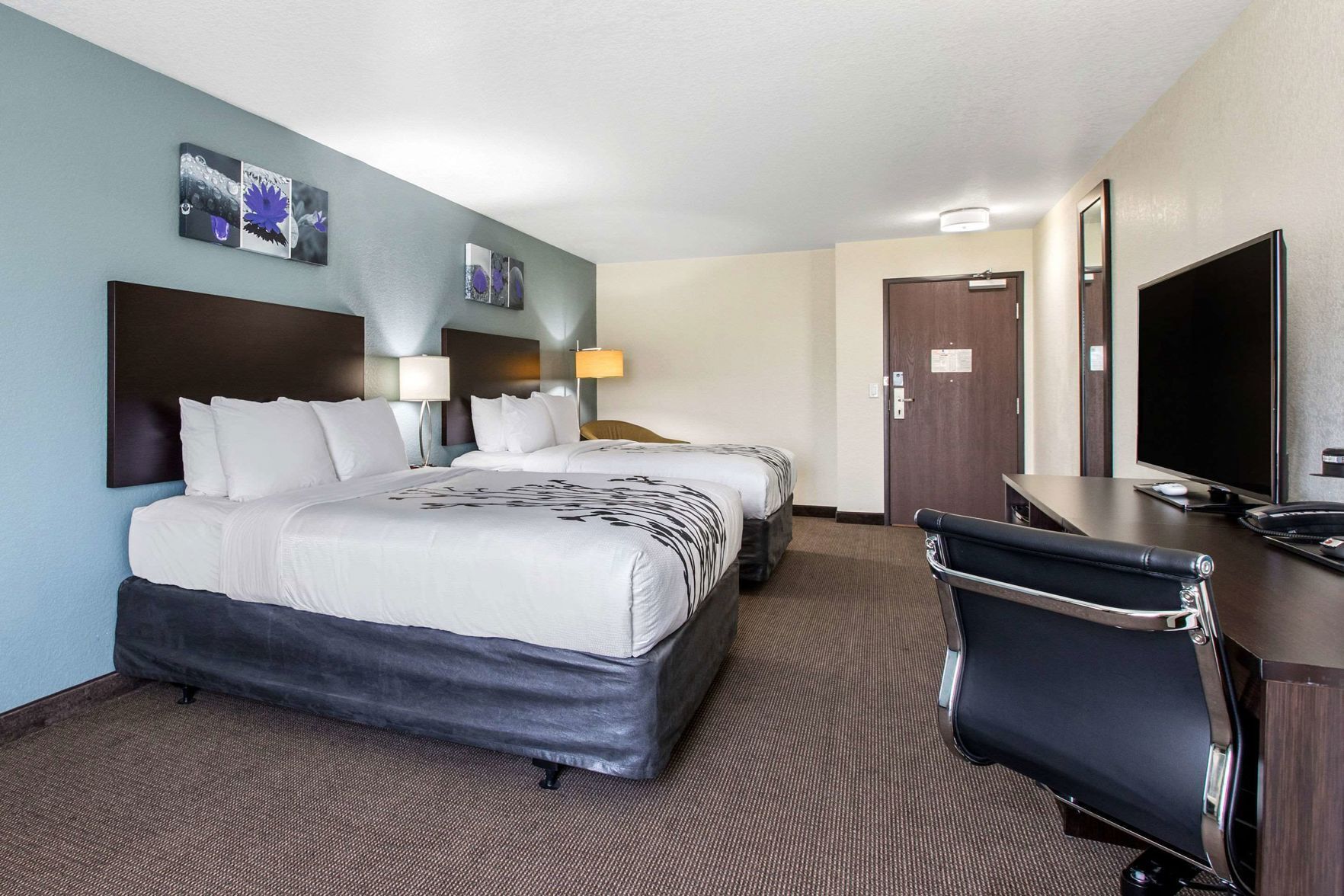 Desk, iron/ironing board, bed sheets