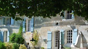 A rustic stone building with multiple windows and shutters, surrounded by greenery. - Pretty Farmhouse / Private pool / 4 Doubles with en-suites & 1 Twin  / Sleeps 10 (Saint-Séverin)