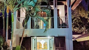 A two-story building with a balcony and a staircase leading to the entrance. - Luxury villa, private beach, infinity pool. Fully serviced. Beautiful sunsets (koh chang)