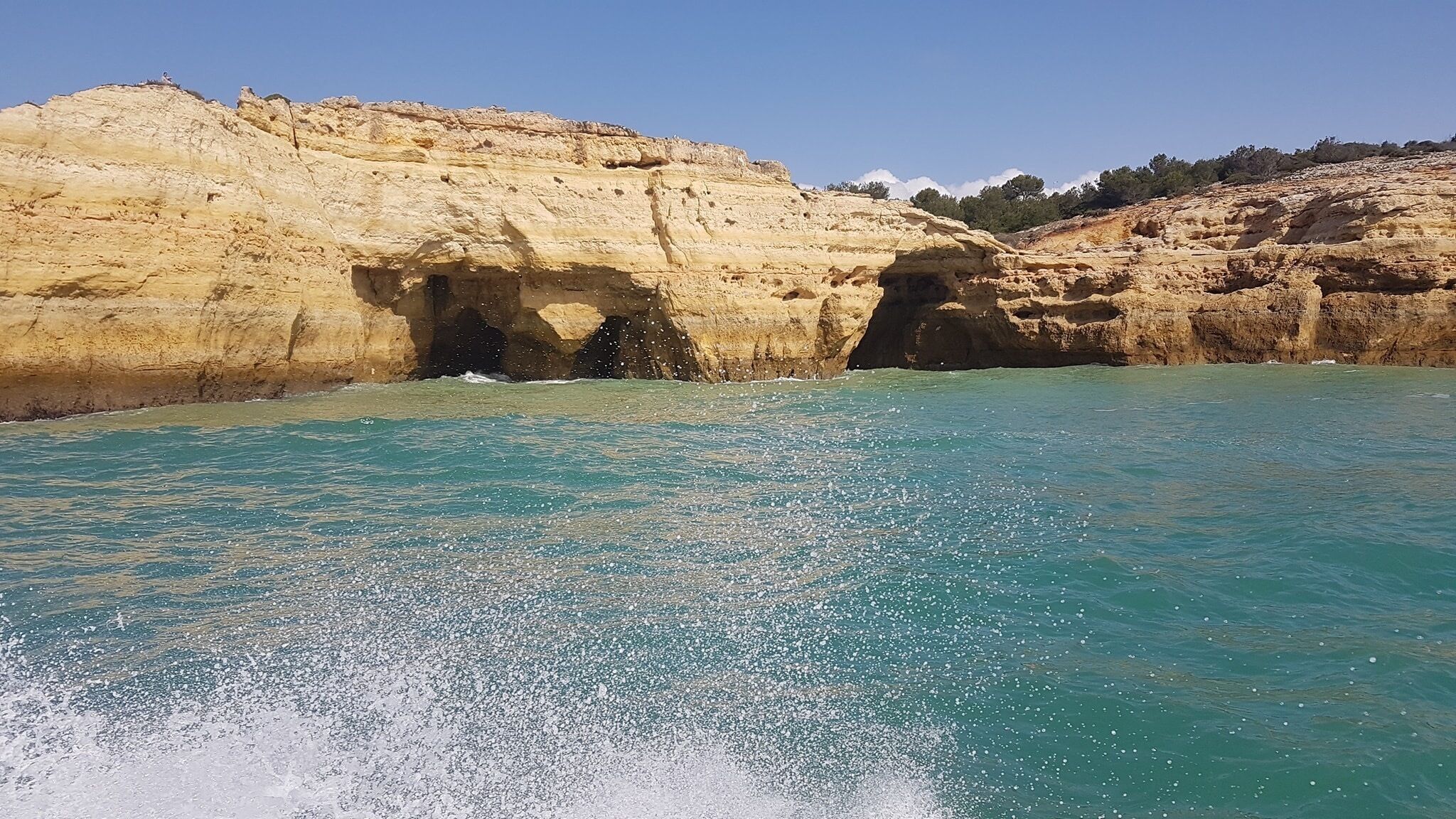 Un paisaje costero con acantilados rocosos y aguas turquesas cristalinas.