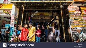 The entrance to Chungking Mansions, a shopping mall with a prominent sign and various shops and advertisements around. - Premium Lounge (Kowloon)