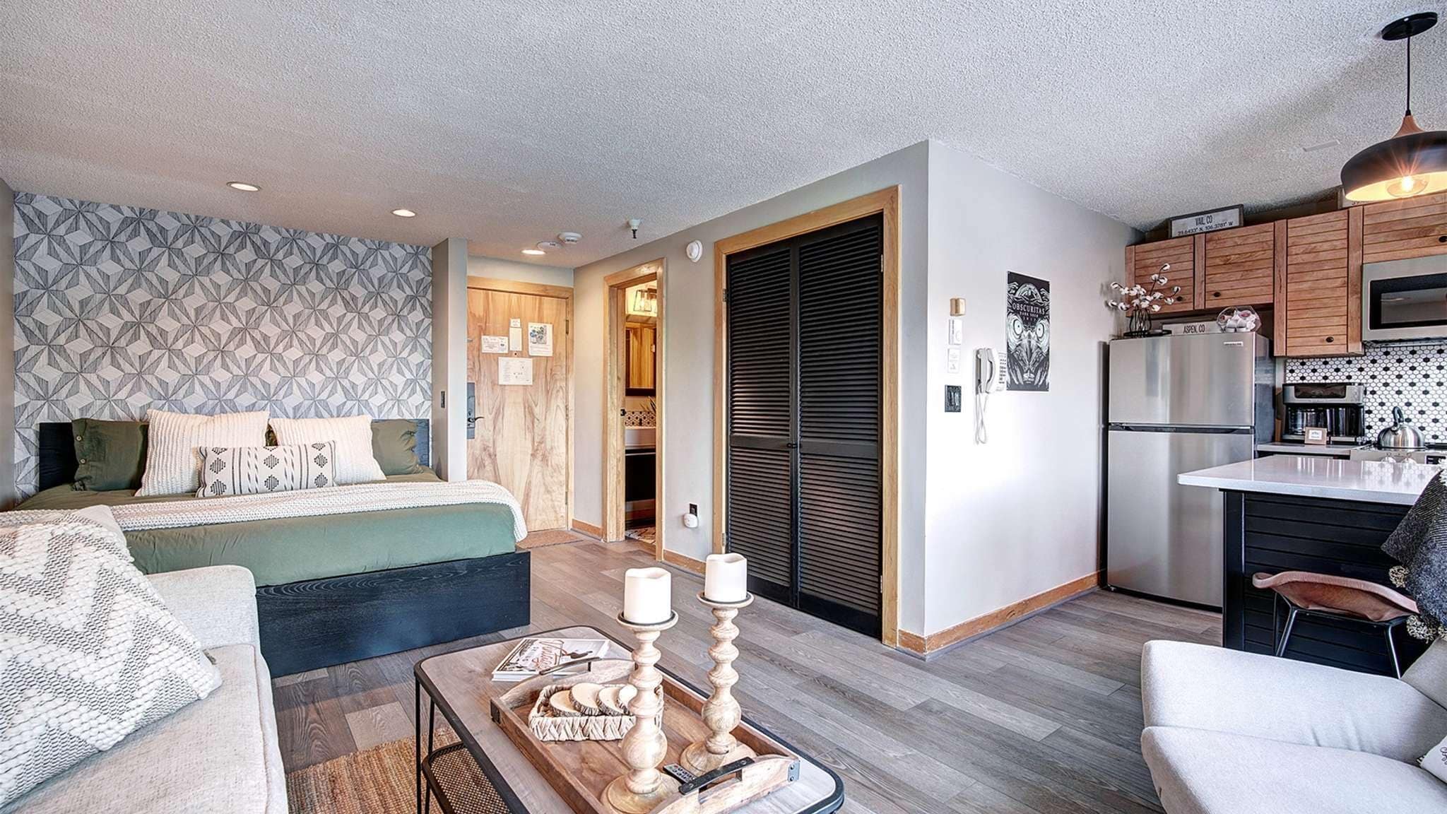 A modern apartment with a living room, bedroom, and kitchen.