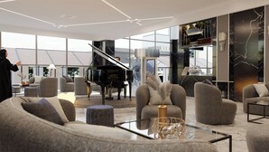 A modern living room with a grand piano, comfortable seating, and a large window offering a view of the city.
