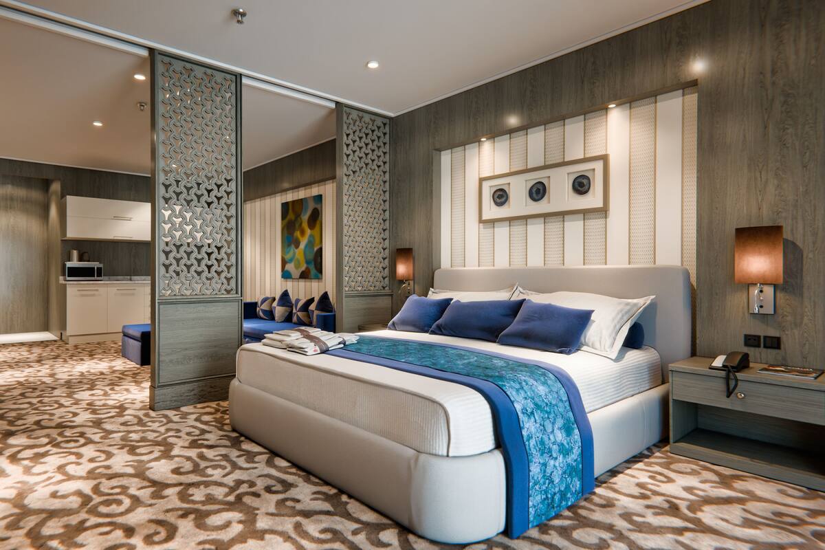 Une chambre à coucher moderne avec un grand lit, une table de chevet et un bureau.