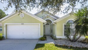 A single-story house with a garage, a front door, and a small garden area with rocks and plants. - MARCH SPECIAL  AVAILABLE! (Davenport)