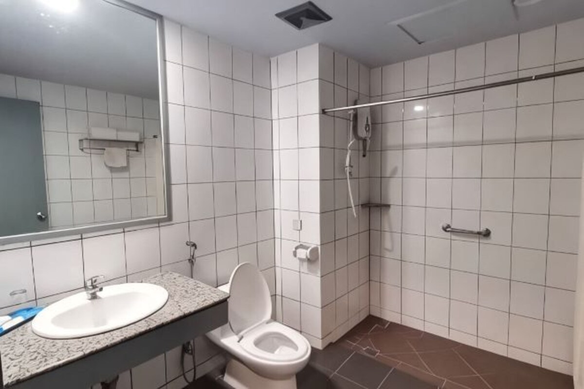 A bathroom with a sink, toilet, and shower.