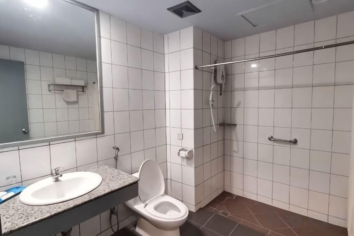 A bathroom with a sink, toilet, and shower.