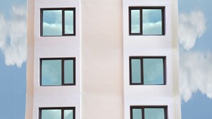 A hotel with a modern design, featuring a flat facade and multiple windows. The hotel has a reception area with a counter and seating. - Hotel Winner Inn (Amritsar)
