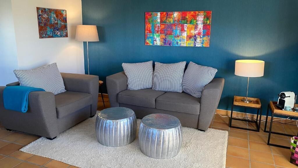 A living room with two sofas, a coffee table, and a lamp.