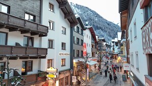 A hotel named 'Hotel Kristall' with a balcony, a sign for 'Friseur MARCH Salon', and a 'BOS' sign. - Hotel Kristall (Sankt Anton am Arlberg)
