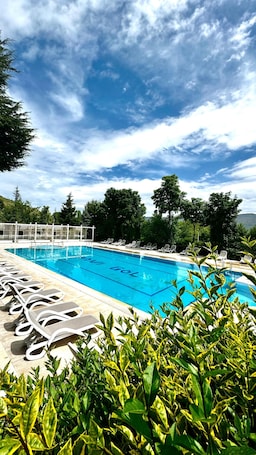Seasonal outdoor pool, open 9 AM to 6:30 PM, pool umbrellas