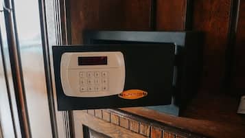 A keypad lock on a door with a wooden frame.