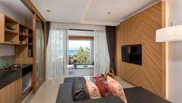 Luxury Beachfront Suite | Living area | Flat-screen TV