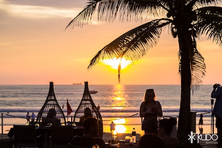 On the beach, white sand, beach towels, beach bar