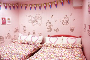 A pink-themed bedroom with two beds, heart-patterned bedding, and Hello Kitty decorations on the walls. - Wai Fuk Guesthouse (Kowloon)