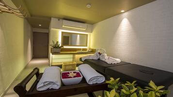 Relax in a serene spa room with a massage table, bench, and soothing ambiance.