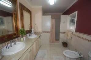 A bathroom with two sinks, a shower, and a toilet. - San Bar 6BR by Jamaican Treasures (Port Antonio)